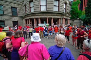 PDX people link arms in a dance that celebrates the earth.